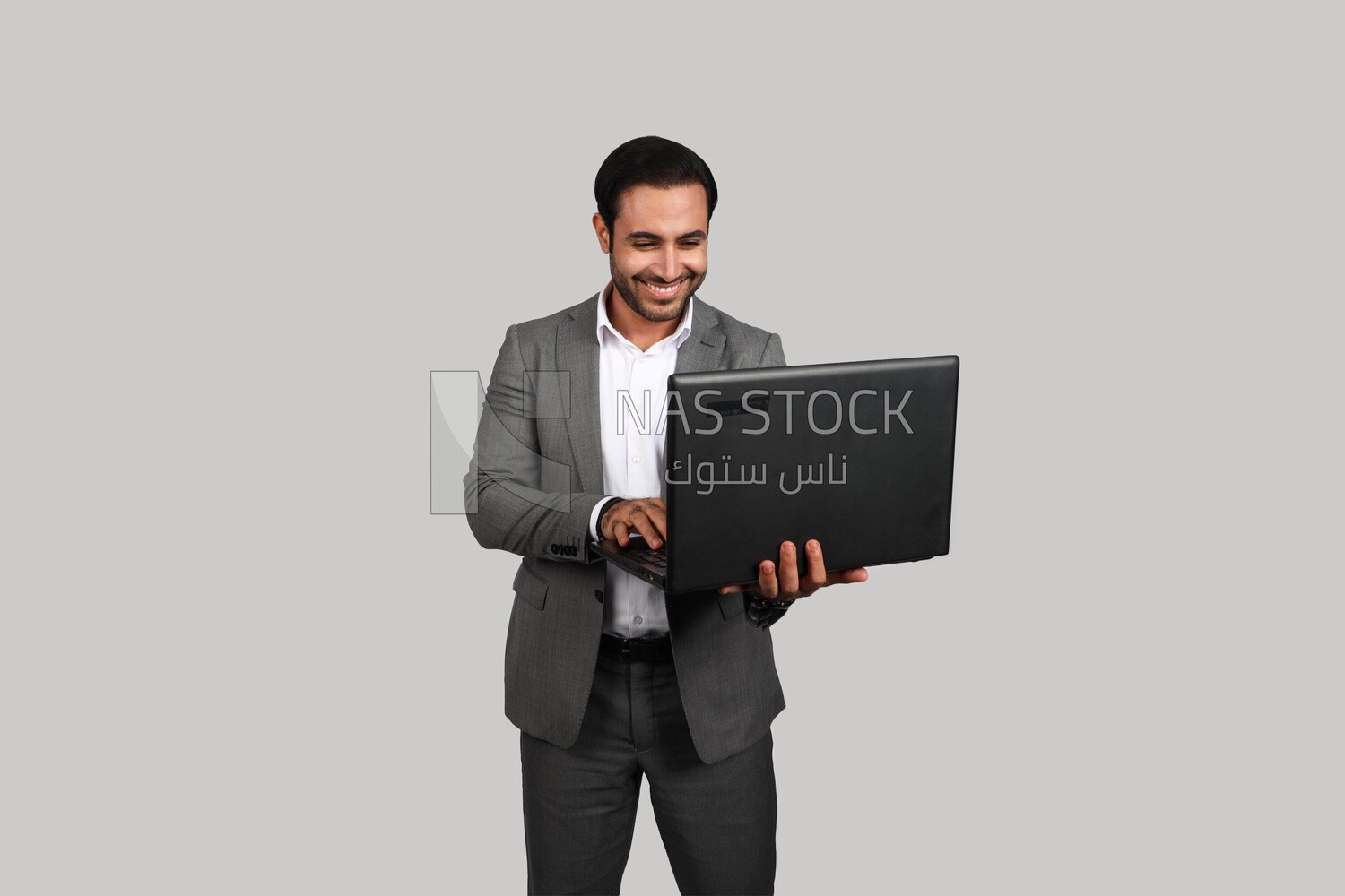 Photo of a businessman with a formal suit holding a laptop, business development and partnerships, business meeting, Model