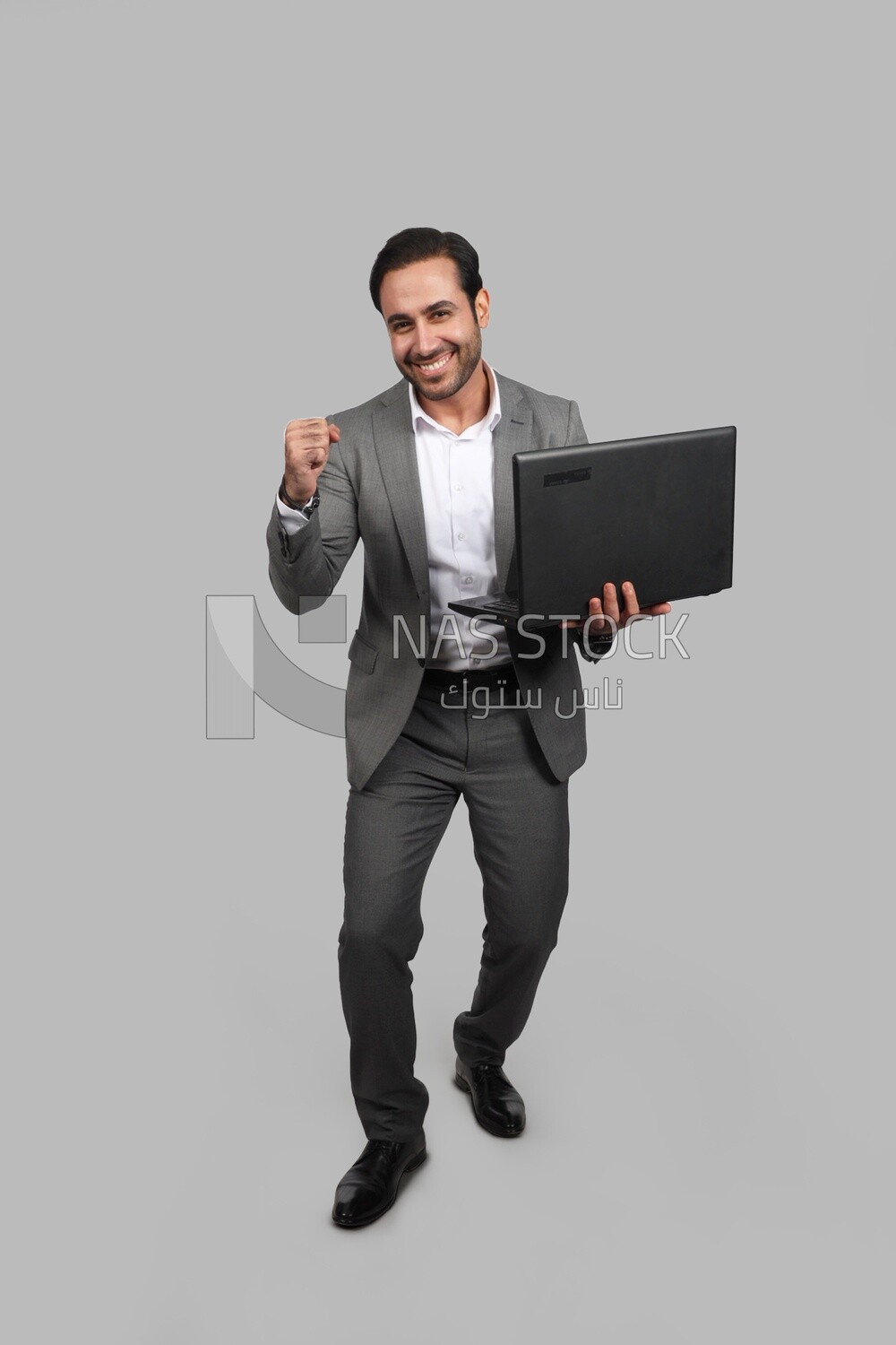 Photo of a businessman with a formal suit holding a laptop, business development and partnerships, business meeting, Model