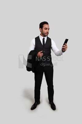 Photo of a businessman with a formal suit checking his mobile phone, business development and partnerships, business meeting, Model