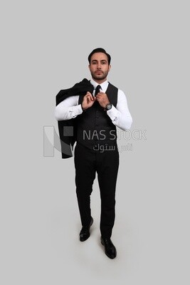 Photo of a businessman with a formal suit putting his hand on the tie, business development and partnerships, business meeting, Model