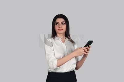 Photo of a businesswoman with formal wear holding a mobile phone, business development and partnerships, business meeting, Model