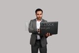 Photo of a businessman with a formal suit holding a laptop, business development and partnerships, business meeting, Model