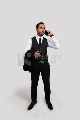 Photo of a businessman with a formal suit talking in his mobile phone, business development and partnerships, business meeting, Model