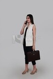 Photo of a businesswoman with formal wear holding a leather bag while talking on the phone, business development and partnerships, business meeting, Model