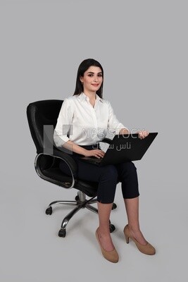 Photo of a businesswoman with formal wear sitting on a chair working on a laptop, business development and partnerships, business meeting, Model