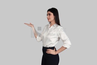 Photo of a businesswoman with formal wear pointing away, business development and partnerships, business meeting, Model