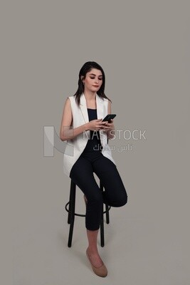 Photo of a businesswoman with formal wear sitting on a chair and taking a selfie, business development and partnerships, business meeting, Model