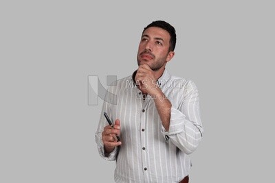 Photo Of a Handsome man standing looks thinking, Smiling Man, Wearing Casual Clothes Posing In a Light Room Interior, Smiling At the Camera, looking away