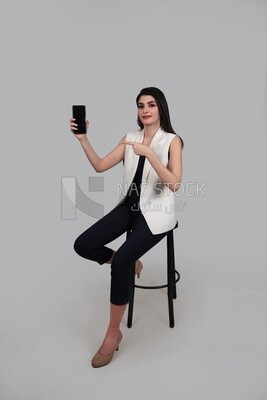 Photo of a businesswoman with formal wear holding a mobile phone, business development and partnerships, business meeting, Model