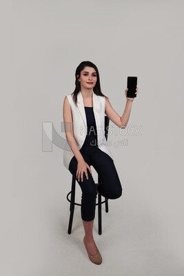 Photo of a businesswoman with formal wear holding a mobile phone, business development and partnerships, business meeting, Model