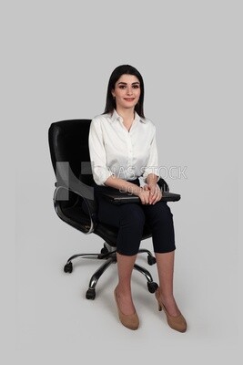 Photo of a businesswoman with formal wear sitting on a chair holding a laptop, business development and partnerships, business meeting, Model