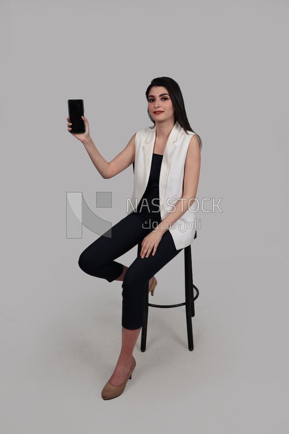 Photo of a businesswoman with formal wear holding a mobile phone, business development and partnerships, business meeting, Model
