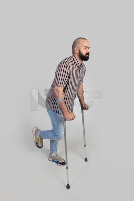 man with an injured leg walking with crutches, patient, medicine and health care concept, medical professions and jobs.
