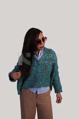 woman wearing glasses and arranging her hair