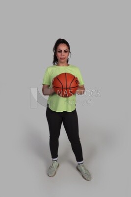 girl in sportswear getting ready to throw a basketball