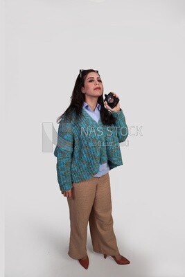 pretty girl spraying perfume on her clothes