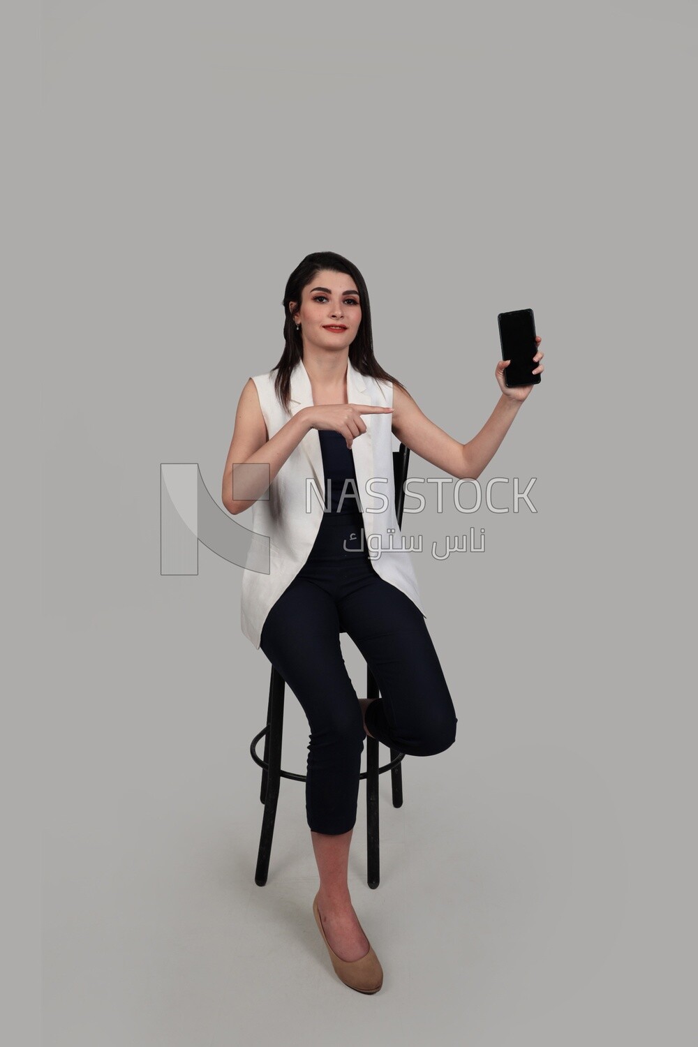 Photo of a businesswoman with formal wear holding a mobile phone, business development and partnerships, business meeting, Model