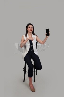 Photo of a businesswoman with formal wear holding a mobile phone, business development and partnerships, business meeting, Model