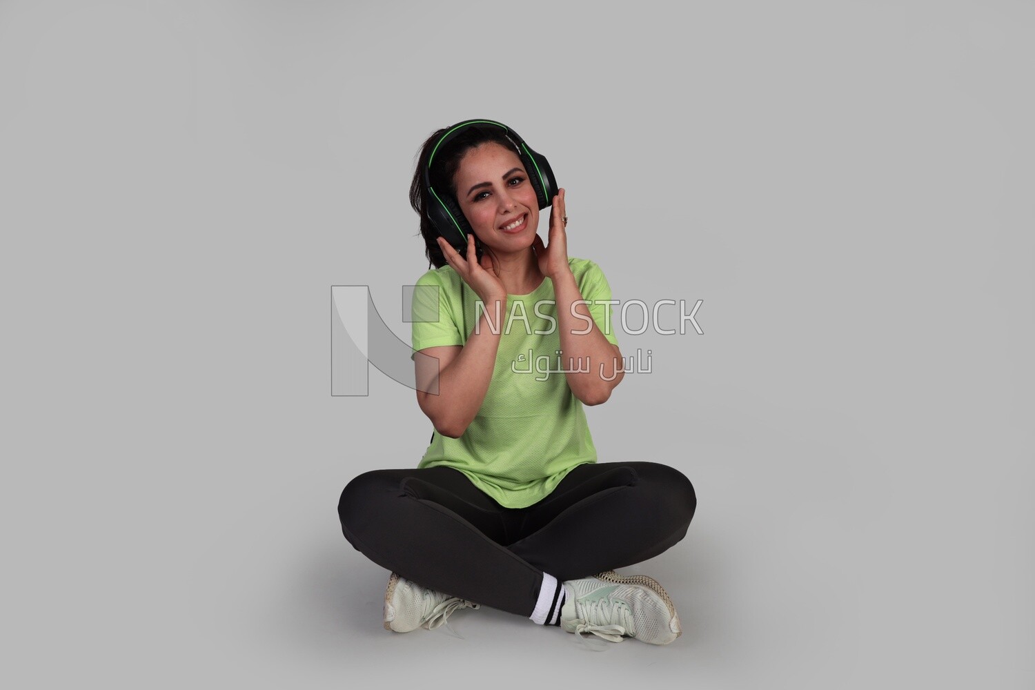 beautiful girl in sportswear sitting and listening to music