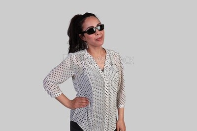 girl wearing sunglasses with her hand on her hip