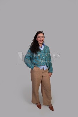 woman standing with her hand in her pocket with long hair