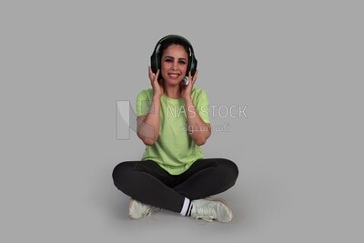 beautiful girl in sportswear sitting and listening to music
