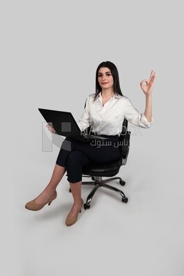 Photo of a businesswoman with formal wear sitting on a chair working on a laptop, business development and partnerships, business meeting, Model