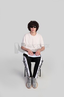 blind man wearing glasses and using Braille to read a book