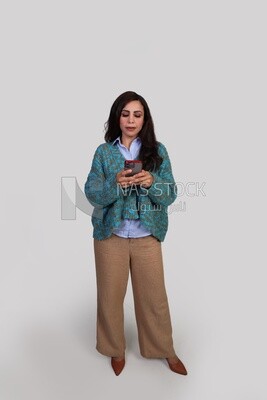 girl wearing winter clothes browsing her phone