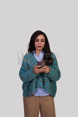 girl wearing winter clothes browsing her phone
