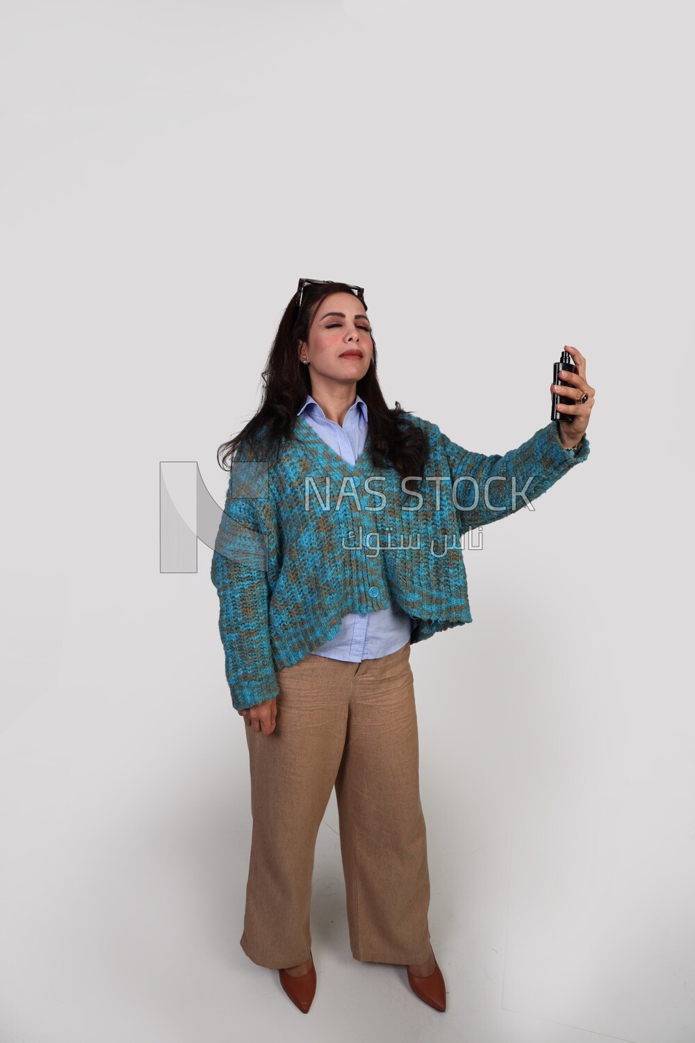 elegant girl getting ready to go and using perfume