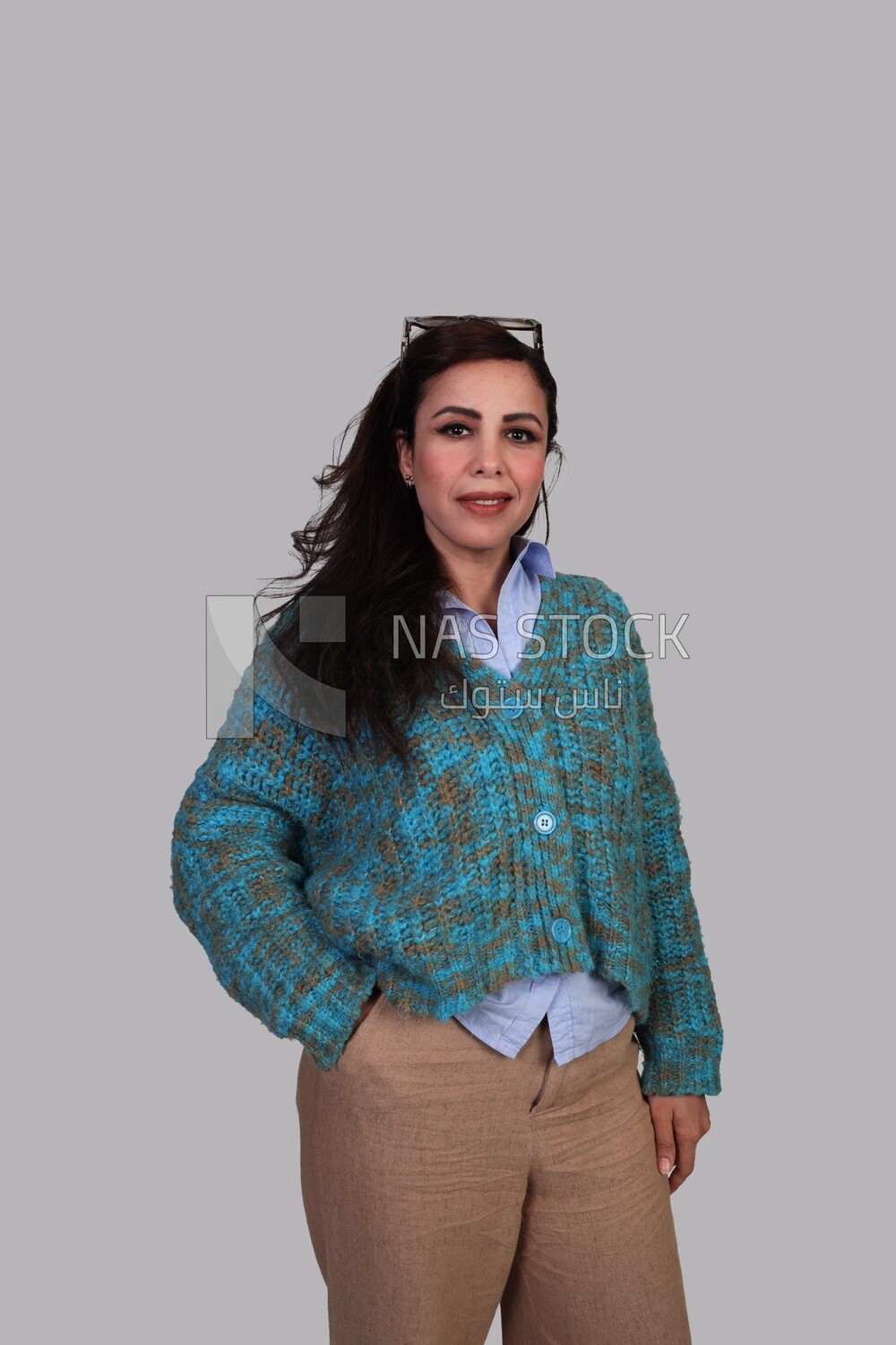woman in autumn clothes standing and putting her hand in her pocket