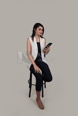 Photo of a businesswoman with formal wear checking the phone, business development and partnerships, business meeting, Model
