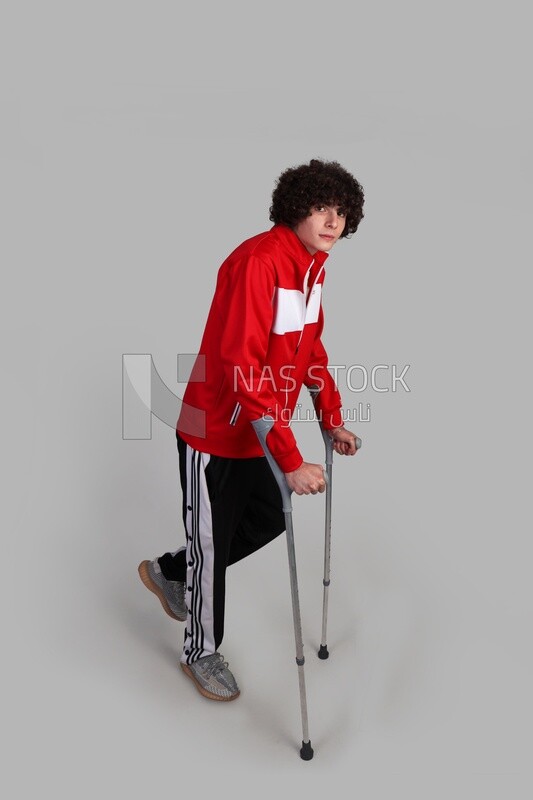 injured sportsman walking with crutches