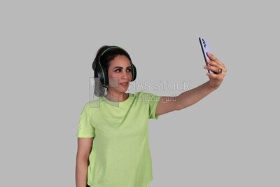 girl listening to music and taking a selfie