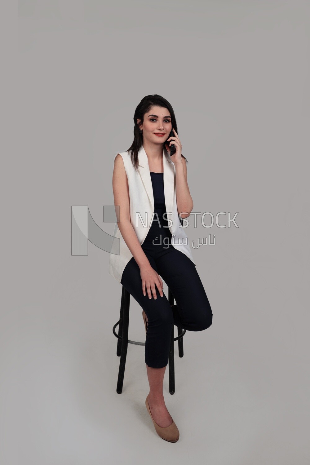 Photo of a businesswoman with formal wear sitting on a chair talking on the phone, business development and partnerships, business meeting, Model