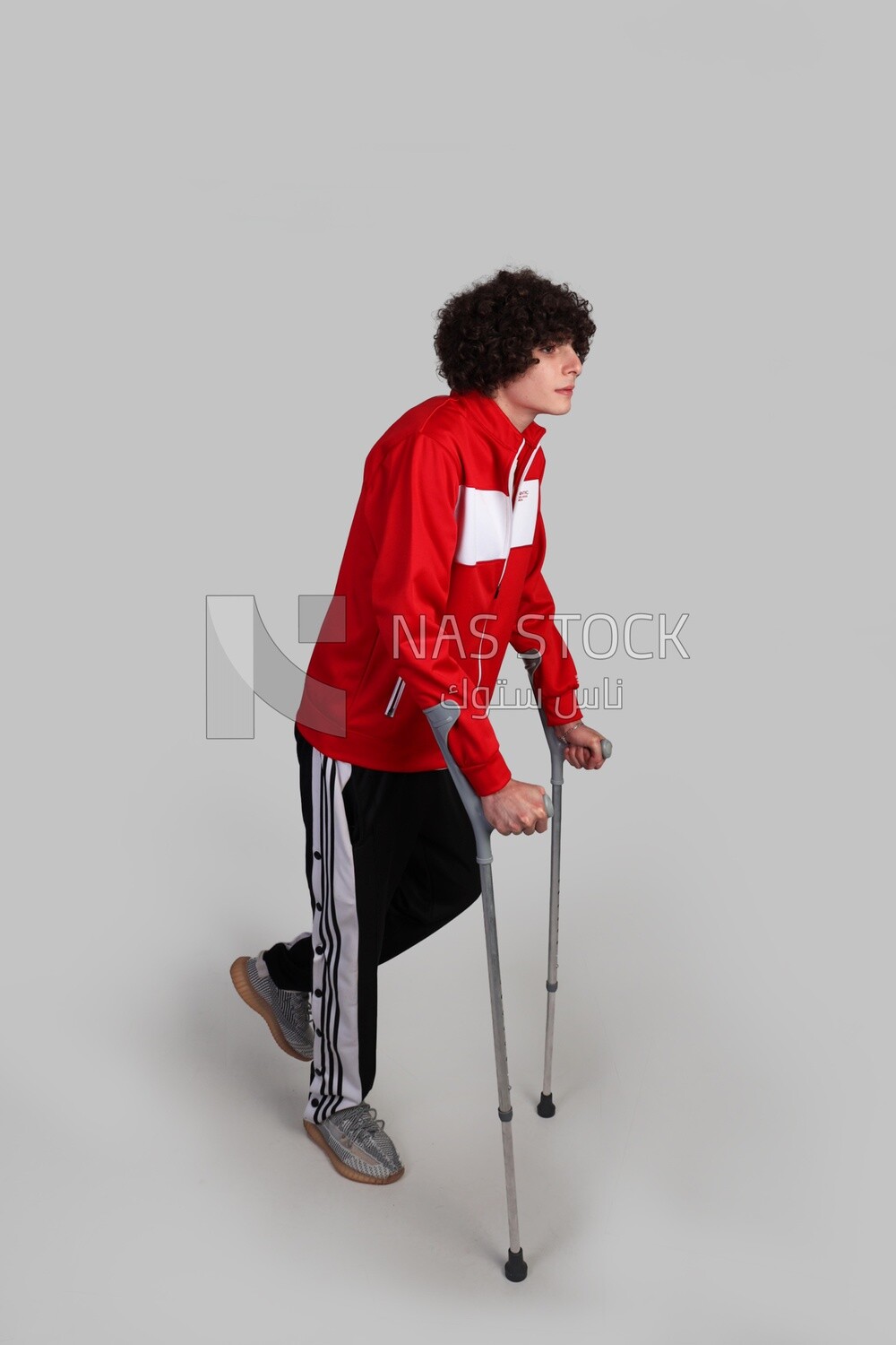 injured sportsman walking with crutches