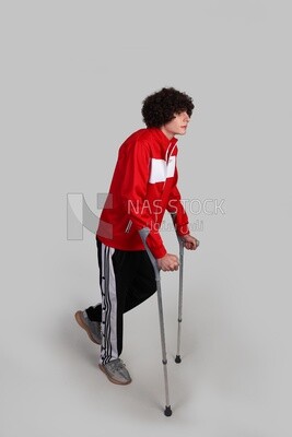 injured sportsman walking with crutches