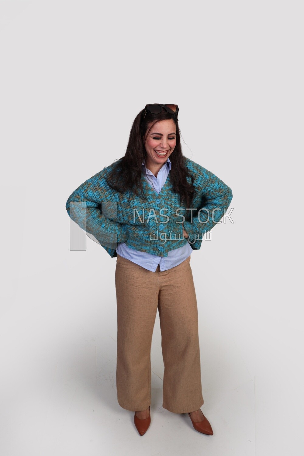 woman laughing hard and placing her hand on her hip