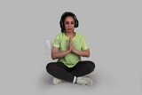 girl practicing yoga and listening to music