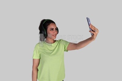 girl listening to music and taking a selfie