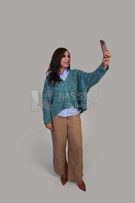 beautiful girl with long hair taking a selfie