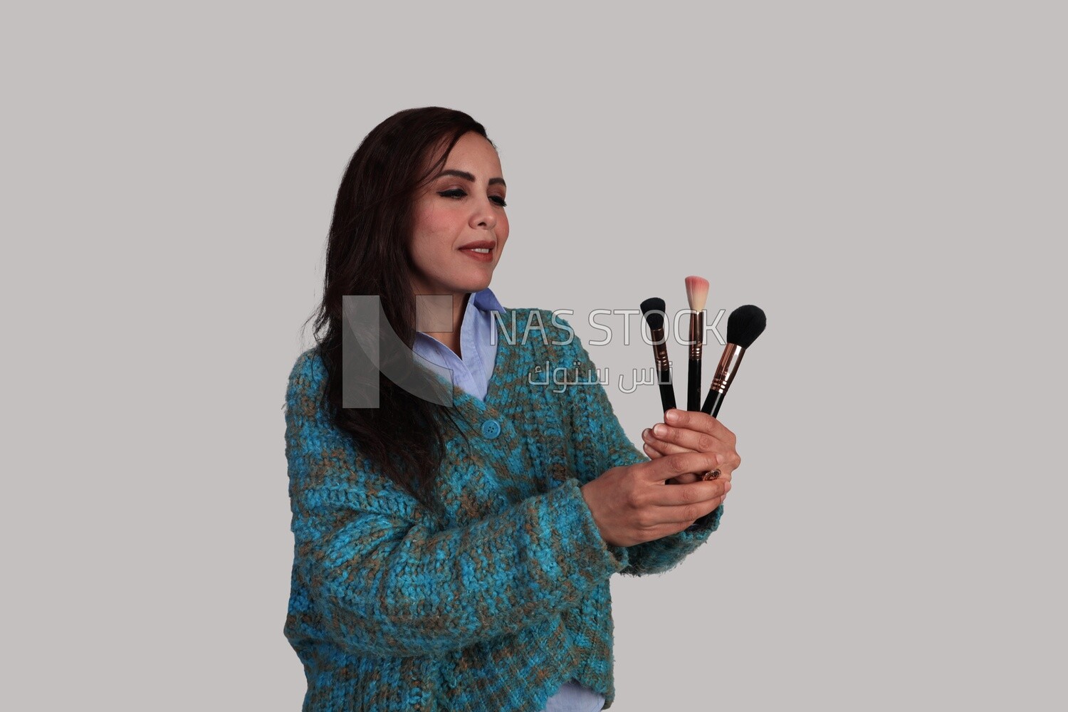 girl holding makeup brushes