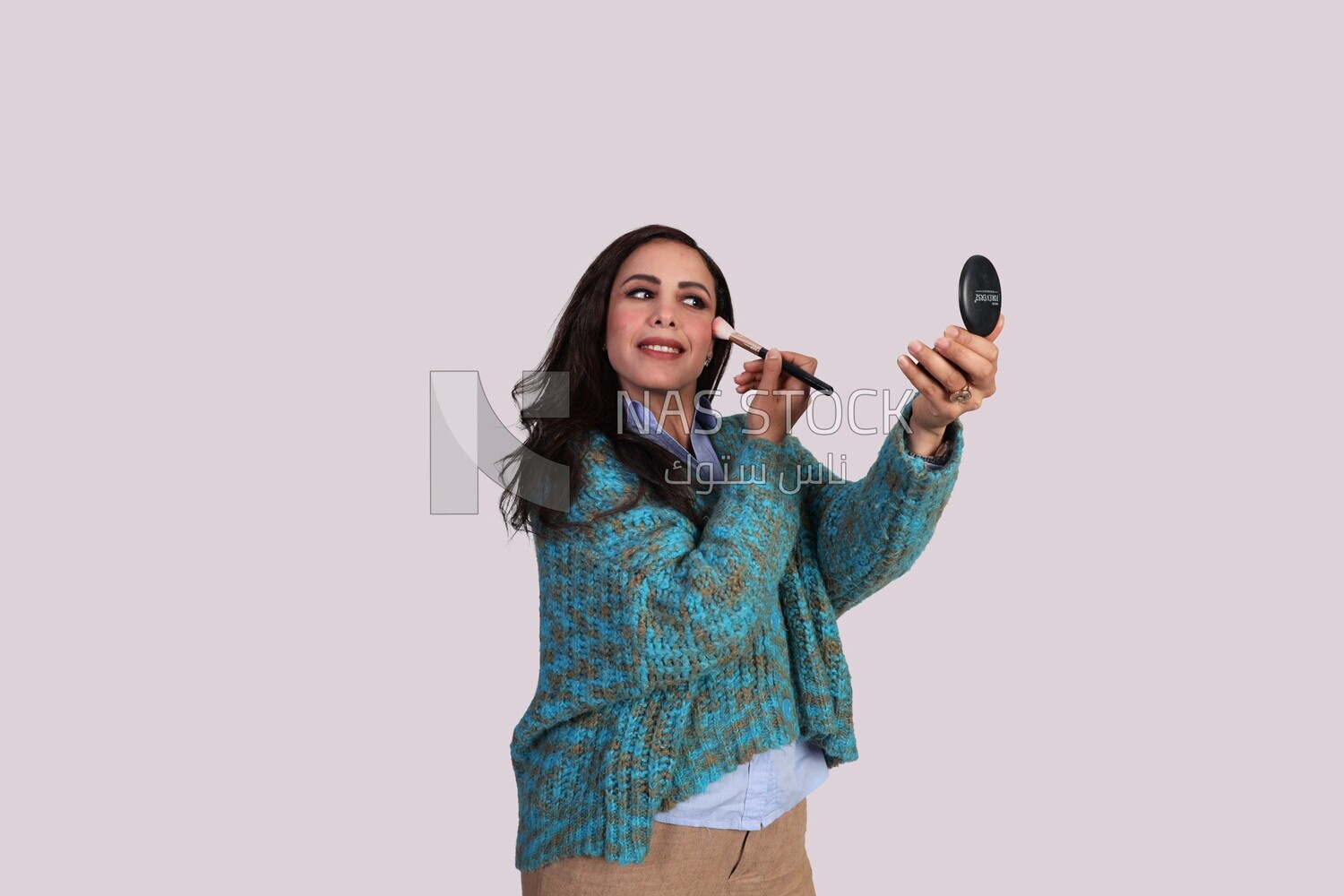 woman adjusting make-up