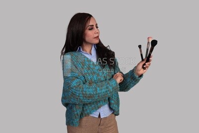 girl holding makeup brushes