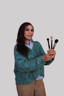 woman holding  makeup brushes
