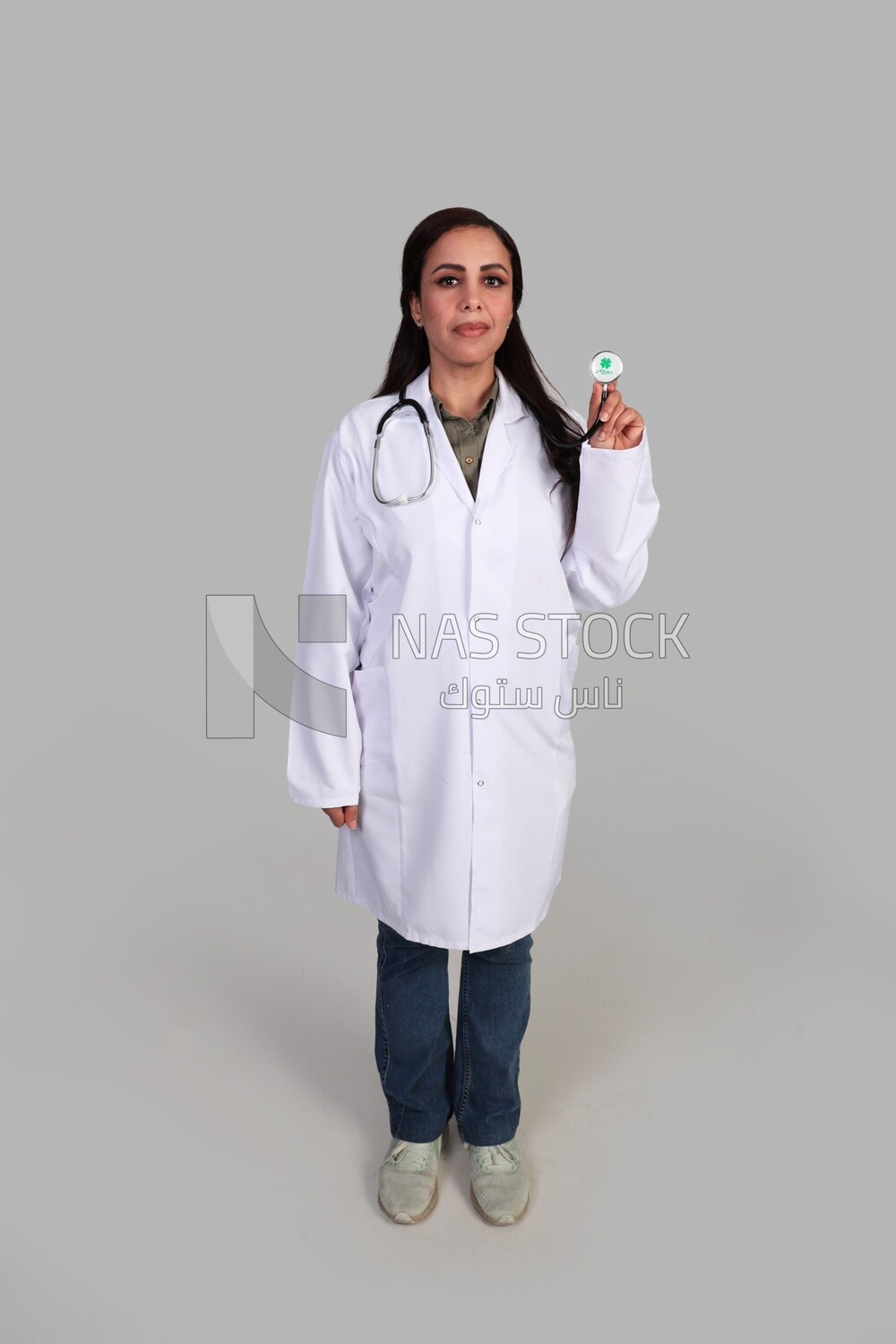 female doctor holding stethoscopes