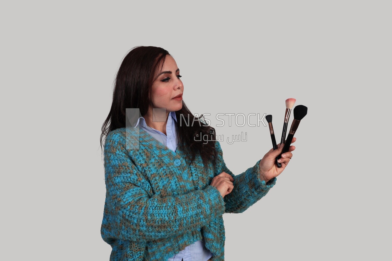 woman holding makeup brushes