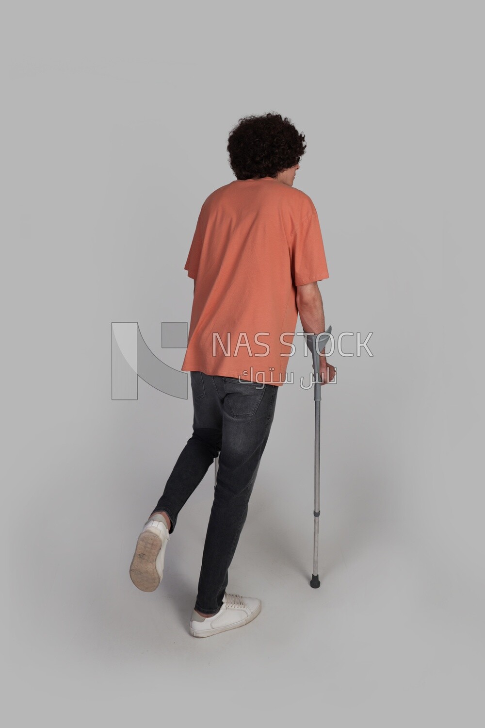 young man leaning on a crutch