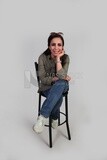 Young woman sitting on a high chair